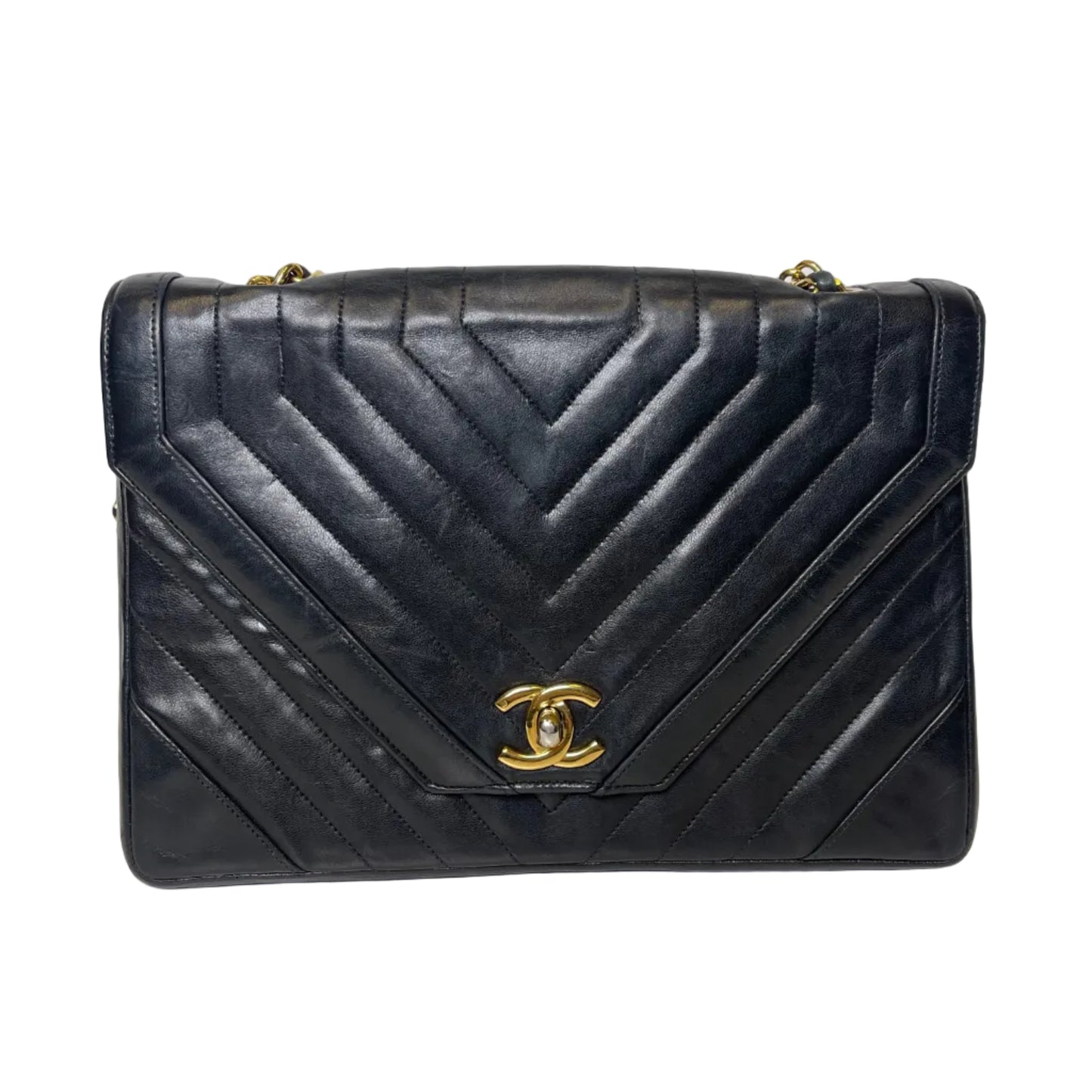 Black quilted handbag with gold Chanel logo on a light gray background